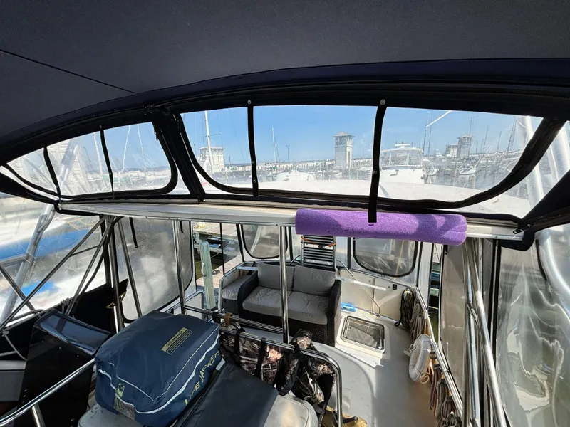 Slide: The Image of Interior view of 1987 Silverton AFT CABIN yacht at marina, featuring seating and equipment. - 20