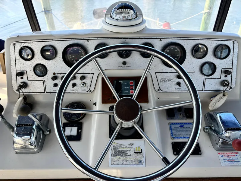 Slide: The Image of 1987 Silverton AFT CABIN boat helm with steering wheel and control panel. - 26