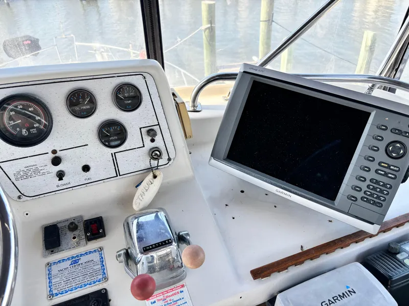 Slide: The Image of 1987 Silverton AFT CABIN helm with gauges and Garmin GPS system. - 27