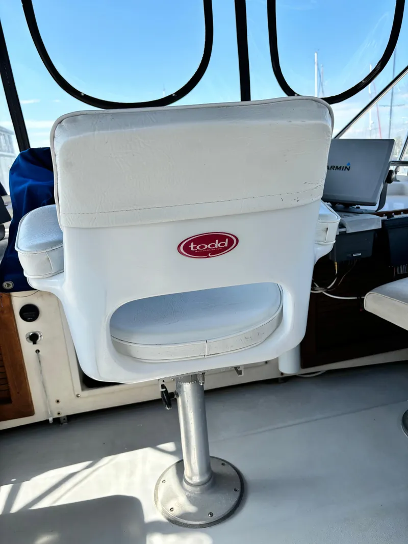Slide: The Image of White captain's chair on 1987 Silverton AFT CABIN boat deck. - 29