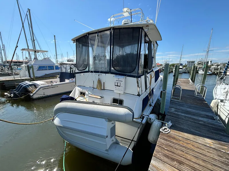 Slide: The Image of 1987 Silverton AFT CABIN boat docked at marina under clear blue sky. - 3