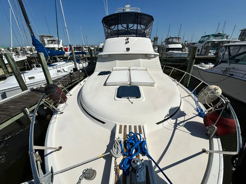 Slide: The Image of 1987 Silverton AFT CABIN boat docked at marina, sunny day, clear sky. - 34