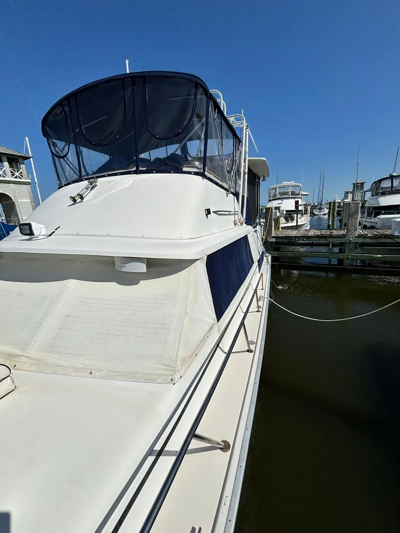 Slide: The Image of 1987 Silverton AFT CABIN yacht docked at marina under clear blue sky. - 35