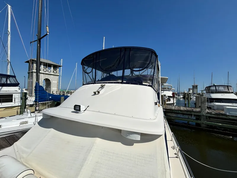 Slide: The Image of 1987 Silverton AFT CABIN yacht docked at marina under clear blue sky. - 36