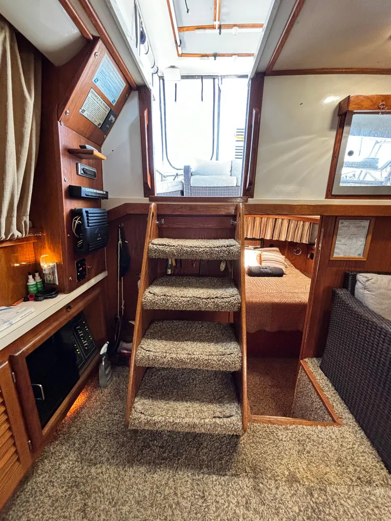 Slide: The Image of 1987 Silverton AFT CABIN interior with carpeted stairs, cozy cabin, and wooden accents. - 37