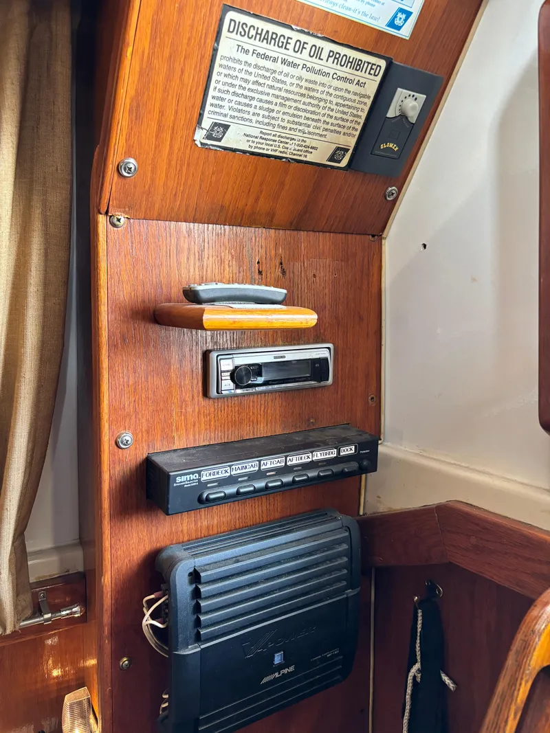 Slide: The Image of 1987 Silverton AFT CABIN interior with control panel and oil discharge notice. - 38