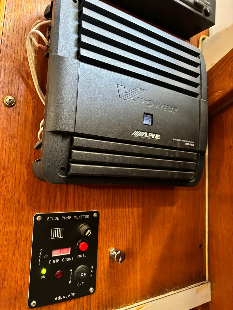 Slide: The Image of 1987 Silverton AFT CABIN boat interior with Alpine amplifier and bilge pump monitor. - 39