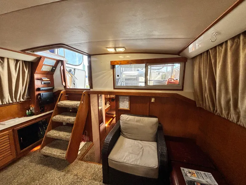 Slide: The Image of 1987 Silverton AFT CABIN interior with cozy seating and wooden accents. - 44