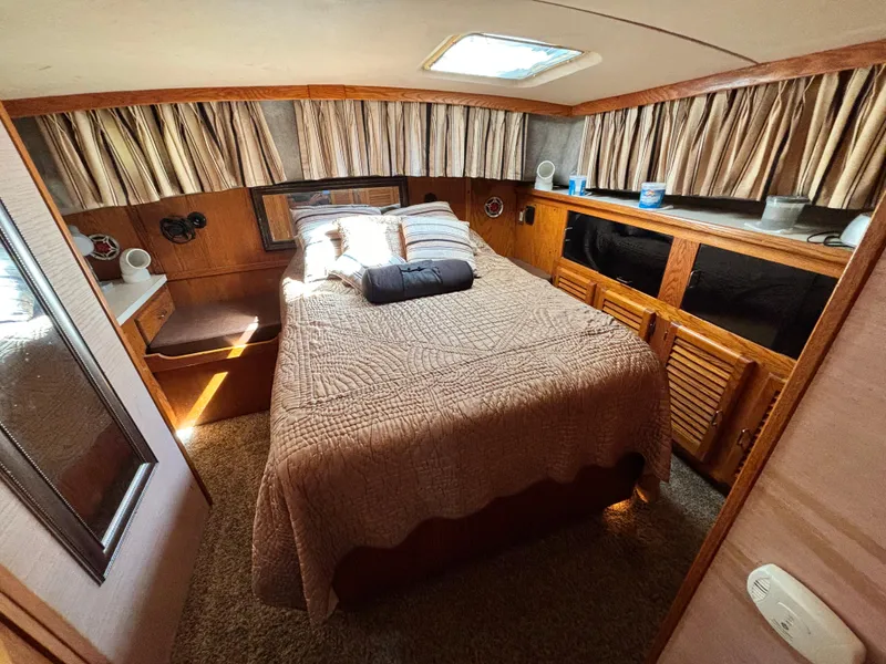 Slide: The Image of Cozy bedroom in 1987 Silverton AFT CABIN yacht with wood accents and natural light. - 45