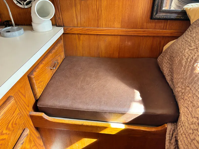 Slide: The Image of 1987 Silverton AFT CABIN interior with brown cushion and wooden cabinetry. - 49