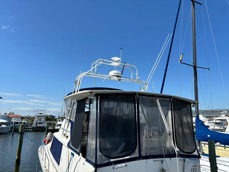 Slide: The Image of 1987 Silverton AFT CABIN boat docked at marina under clear blue sky. - 7