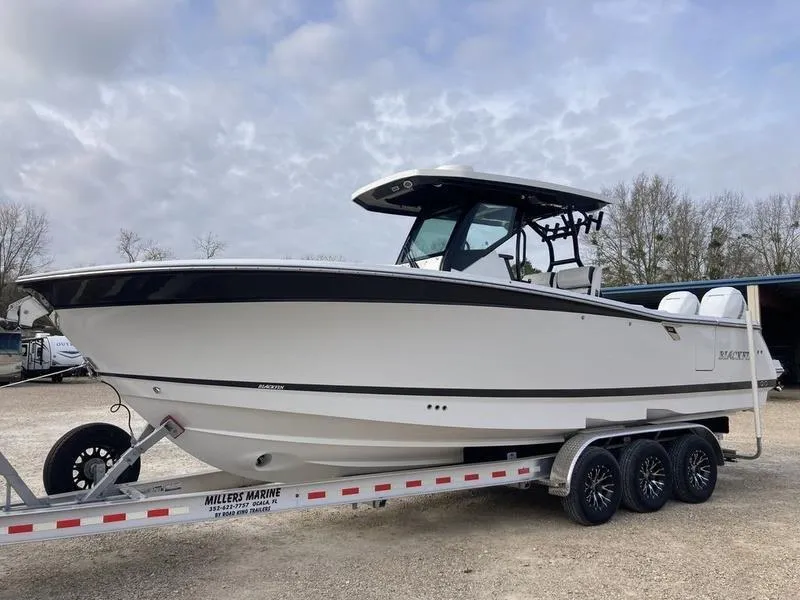 The Image of 2023 Blackfin 302CC boat on a trailer at a marina. - 0
