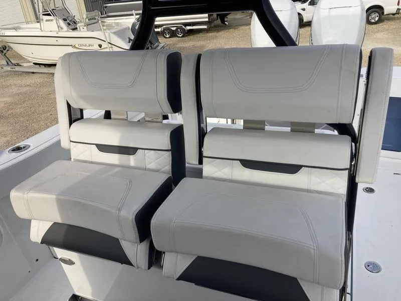 Slide: The Image of 2023 Blackfin 302CC boat seating with white and black cushioned seats. - 10