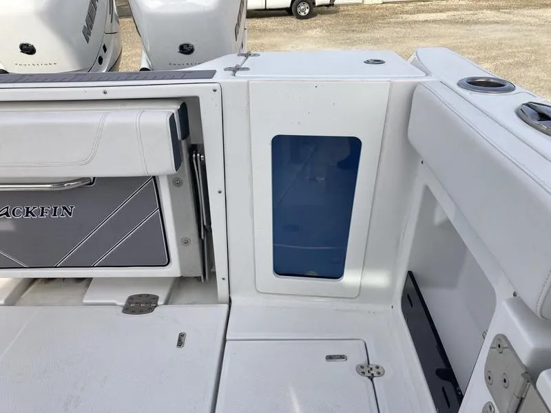 Slide: The Image of 2023 Blackfin 302CC boat deck with storage compartments and seating. - 11
