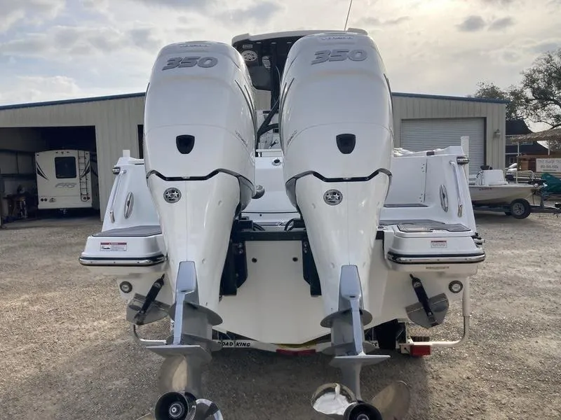 Slide: The Image of 2023 Blackfin 302CC boat with twin 350 horsepower engines, rear view. - 2