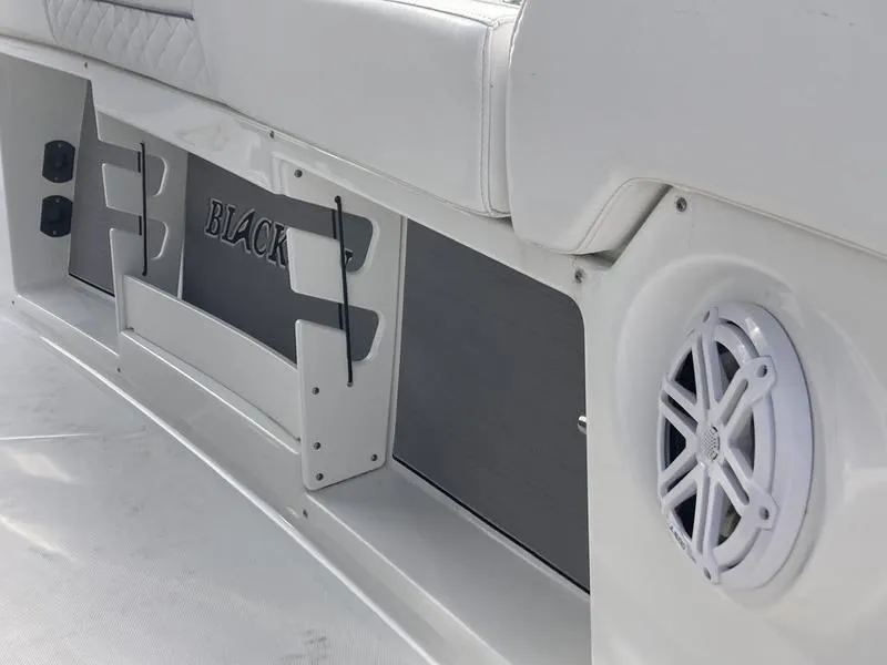 Slide: The Image of 2023 Blackfin 302CC boat interior with speaker and storage compartments. - 7