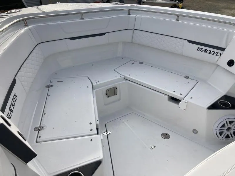 Slide: The Image of 2023 Blackfin 302CC boat interior with white seating and storage compartments. - 9