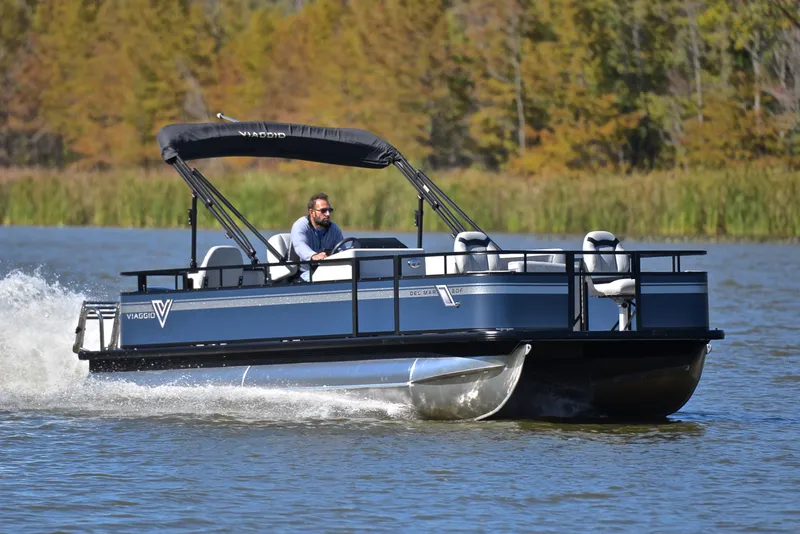 Slide: The Image of 2023 Viaggio DM20F pontoon boat cruising on a lake. - 1