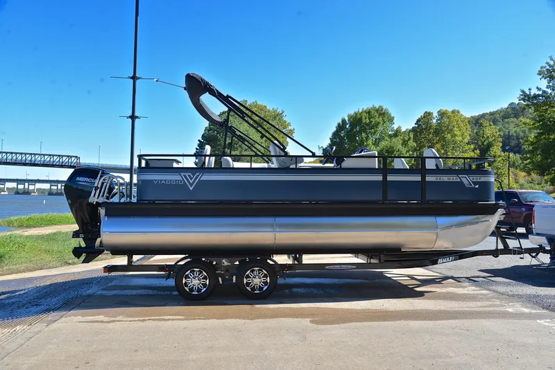 Slide: The Image of 2023 Viaggio DM20F pontoon boat on trailer by a riverside. - 13