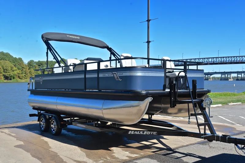 Slide: The Image of 2023 Viaggio DM20F pontoon boat on a trailer by the water. - 14