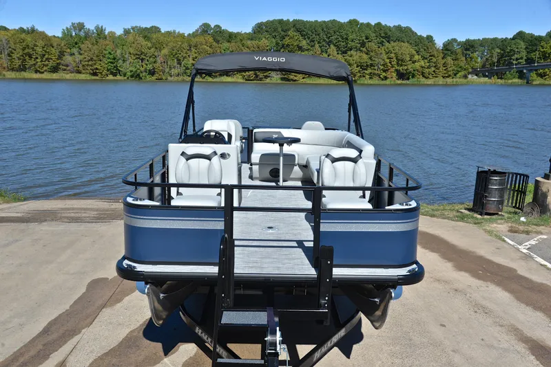 Slide: The Image of 2023 Viaggio DM20F pontoon boat on a trailer by a lake. - 15