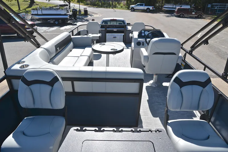 Slide: The Image of 2023 Viaggio DM20F pontoon boat interior with plush seating and steering console. - 16