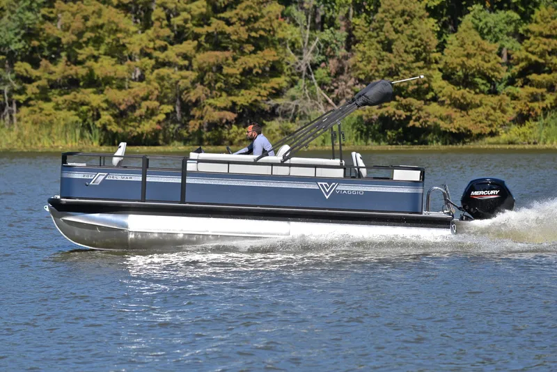 Slide: The Image of 2023 Viaggio DM20F pontoon boat cruising on a lake. - 2