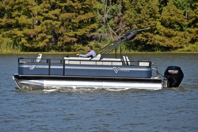 Slide: The Image of 2023 Viaggio DM20F pontoon boat cruising on a lake. - 23