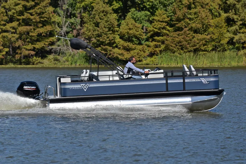 Slide: The Image of 2023 Viaggio DM20F pontoon boat cruising on a lake with a Mercury outboard motor. - 3