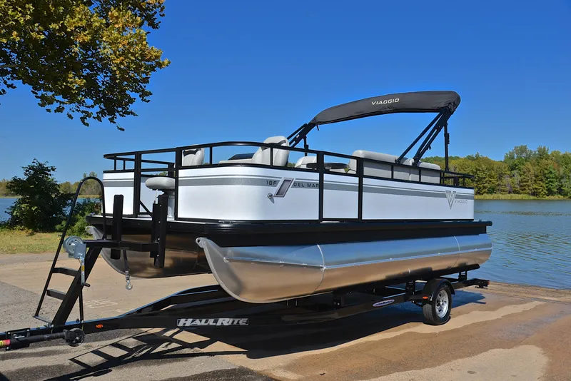 Slide: The Image of 2023 Viaggio DM18F pontoon boat on a trailer by a lake. - 10
