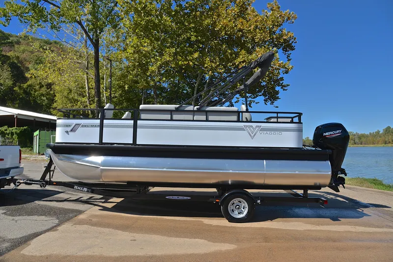 Slide: The Image of 2023 Viaggio DM18F pontoon boat on trailer by a lake. - 11
