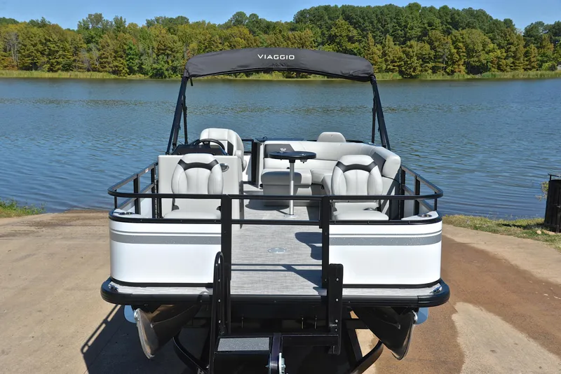 Slide: The Image of 2023 Viaggio DM18F pontoon boat docked by a serene lake. - 17