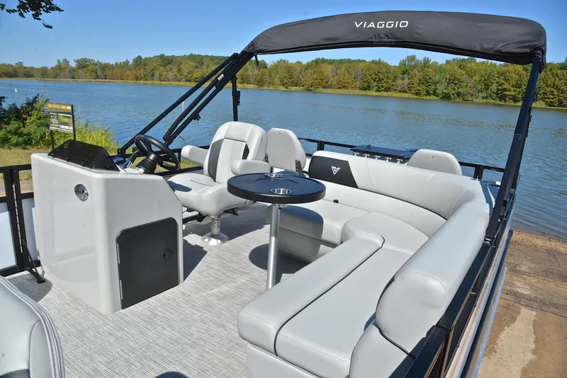 Slide: The Image of 2023 Viaggio DM18F pontoon boat with spacious seating and table on a serene lake. - 20
