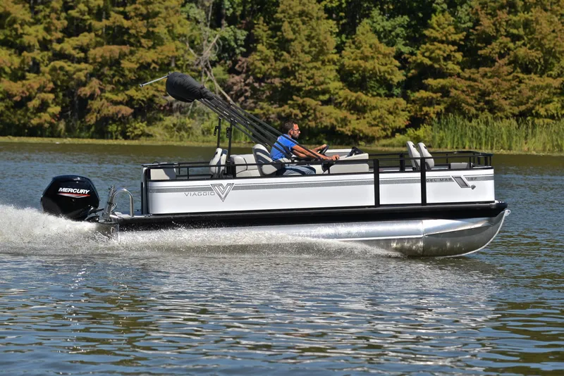 Slide: The Image of 2023 Viaggio DM18F pontoon boat cruising on a lake with a Mercury outboard motor. - 3