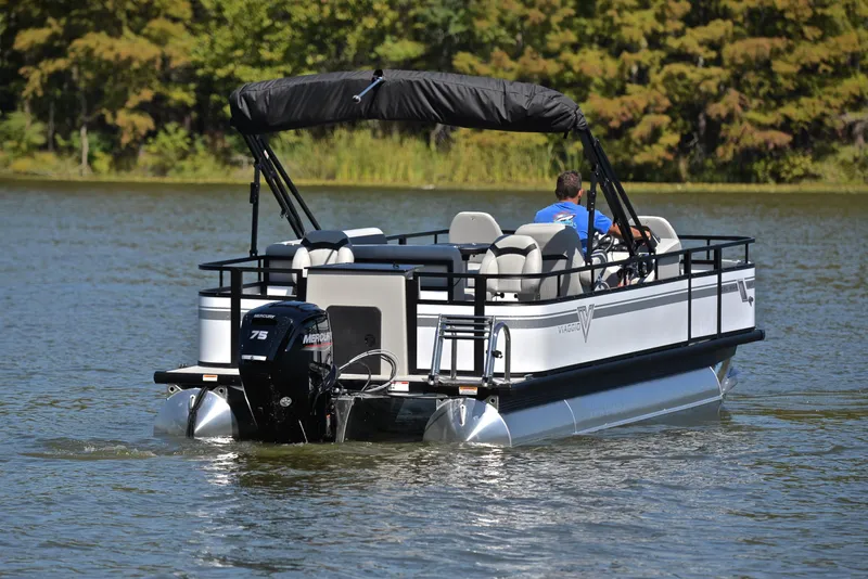 Slide: The Image of Viaggio DM18F 2023 pontoon boat cruising on a lake. - 7