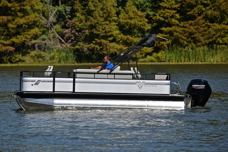 Slide: The Image of 2023 Viaggio DM18F pontoon boat cruising on a lake with a Mercury outboard motor. - 8
