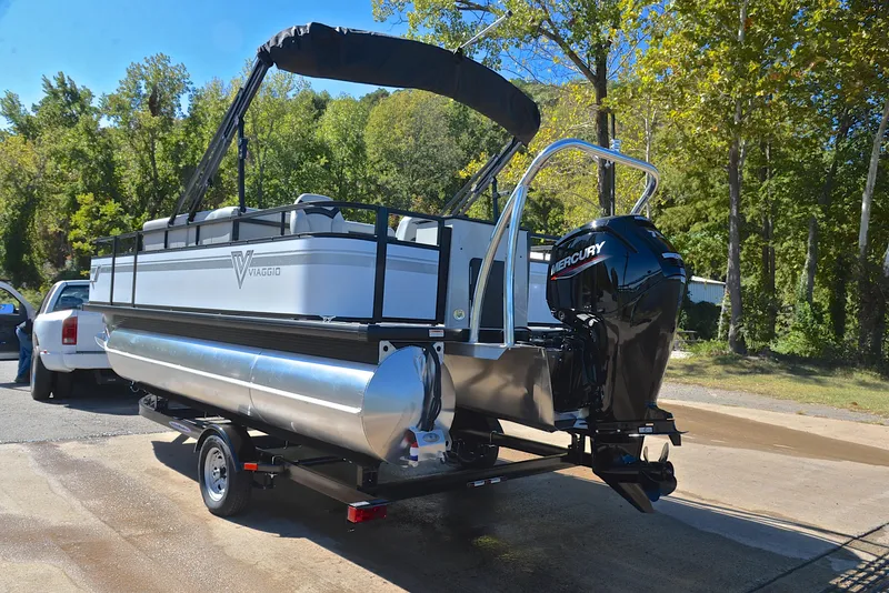 Slide: The Image of 2023 Viaggio DM18F pontoon boat with Mercury outboard motor on trailer. - 11