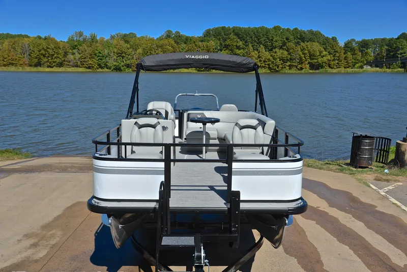 Slide: The Image of 2023 Viaggio DM18F pontoon boat docked by a serene lake. - 16