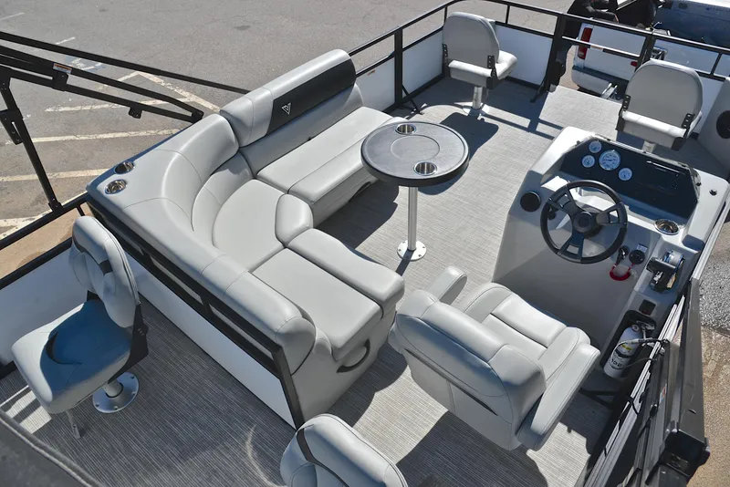 Slide: The Image of 2023 Viaggio DM18F pontoon boat interior with seating, table, and steering console. - 18