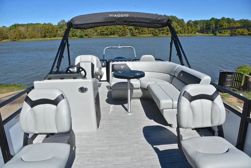 Slide: The Image of 2023 Viaggio DM18F pontoon boat with spacious seating on a serene lake. - 19