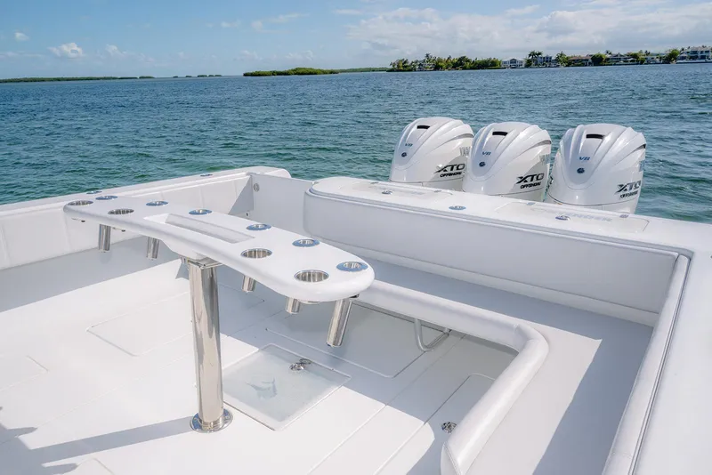 Slide: The Image of Contender 44 ST 2023 with triple outboard engines on calm waters. - 12