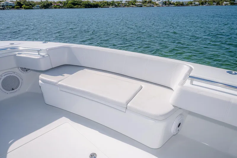 Slide: The Image of 2023 Contender 44 ST boat with white seating area by the water. - 14