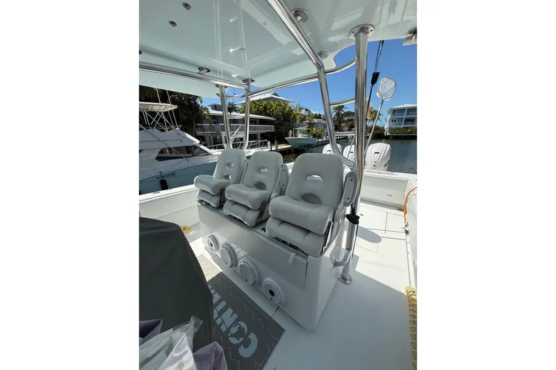 Slide: The Image of 2023 Contender 44 ST boat interior with cushioned seating and sleek design. - 22