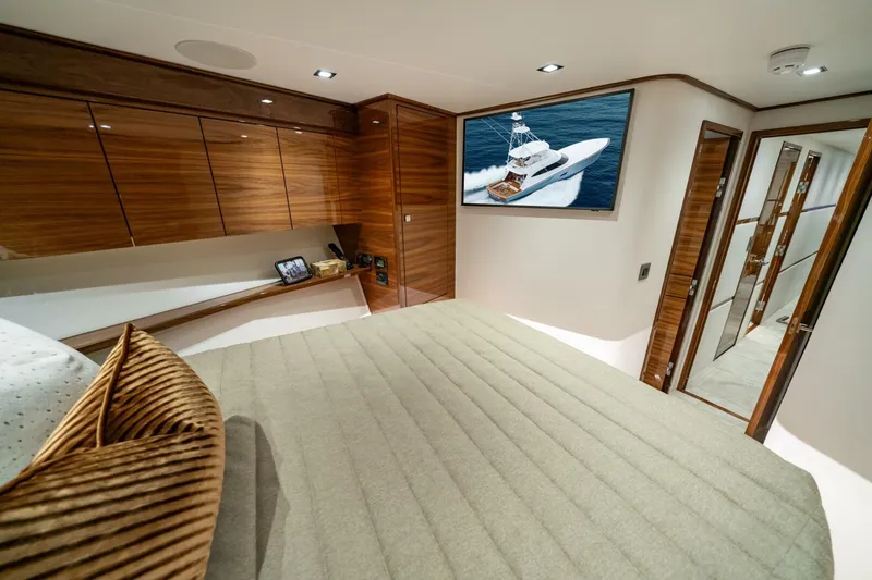 Slide: The Image of Luxurious interior of 2025 Viking 82 Convertible yacht with modern wood finishes. - 18