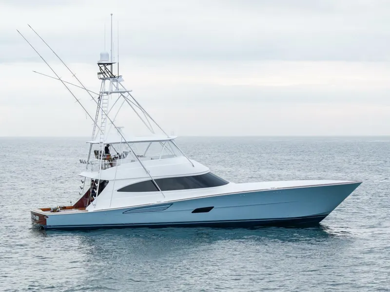 Slide: The Image of 2025 Viking 82 Convertible yacht on calm ocean waters. - 2
