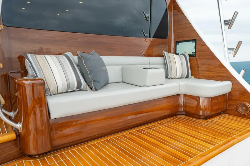 Slide: The Image of Luxurious seating area on 2025 Viking 82 Convertible yacht with elegant wood finish and cushions. - 31