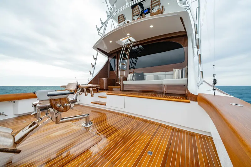 Slide: The Image of 2025 Viking 82 Convertible yacht with polished wooden deck and luxurious seating area. - 32