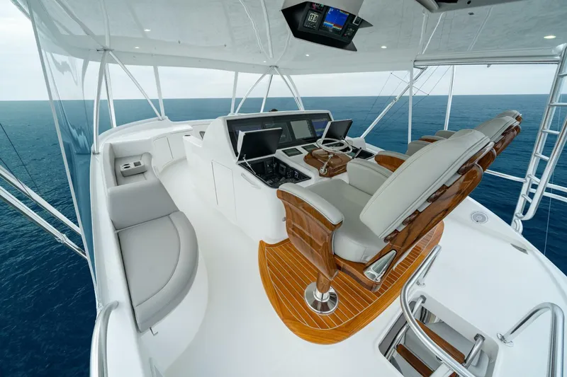 Slide: The Image of 2025 Viking 82 Convertible yacht helm with luxurious seating and advanced navigation systems. - 35