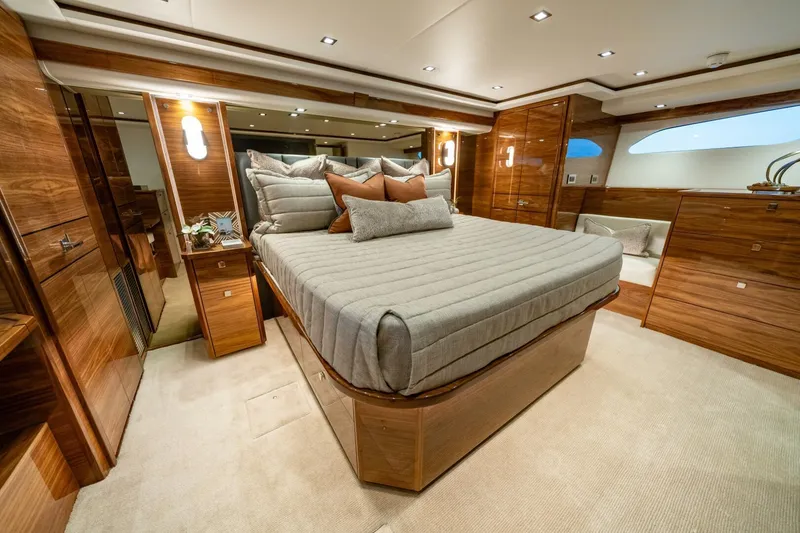 Slide: The Image of Luxurious bedroom interior of 2025 Viking 82 Convertible yacht with elegant wood finishes. - 4