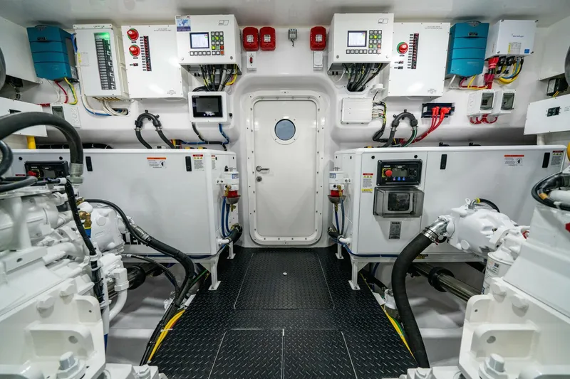 Slide: The Image of Engine room of 2025 Viking 82 Convertible yacht, featuring advanced control panels and equipment. - 44